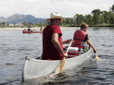 Father and son paddle on Jefferson River, MT.