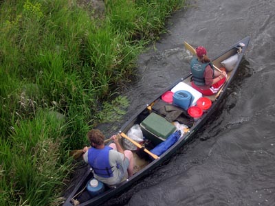 Paddling a canoe loaded for camping.